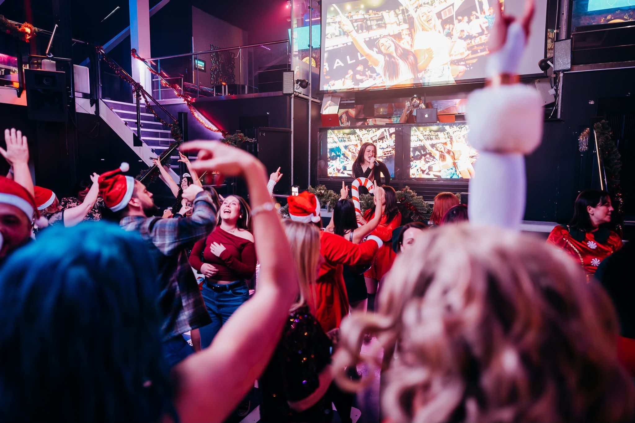 A Christmas dancefloor at Ballin’ Maidstone — Santa hats, candy canes, and the set on the screens